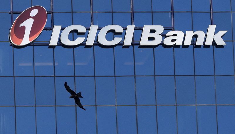 FILE PHOTO: A bird flies past the facade of the ICICI bank head office in Mumbai, India, April 21, 2023. REUTERS/Francis Mascarenhas/File Photo
