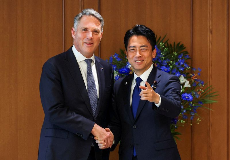 FILE PHOTO: Australia's Deputy Prime Minister and Minister for Defence Richard Marles shakes hands with Japan's Defence Minister Shinjiro Koizumi at the start of their talks at the Defense Ministry in Tokyo, Japan, April 8, 2026. REUTERS/Issei Kato/File Photo