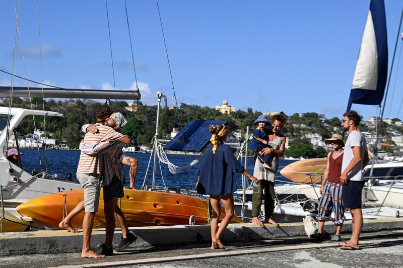 Activists from the Nuestra America Convoy embrace after disembarking in Havana Bay after they were located by the Mexican Navy after they went missing while carrying humanitarian aid from Mexico to Cuba, in Havana, Cuba, March 28, 2026. REUTERS/Norlys Perez