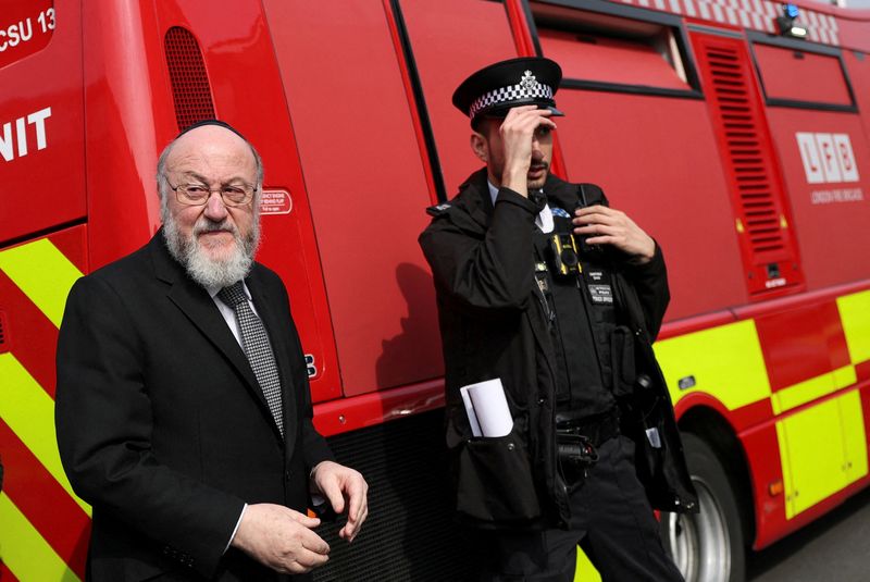 FILE PHOTO: Chief Rabbi Ephraim Mirvis visits the scene after four ambulances belonging to Hatzola, a Jewish community organisation, were set on fire in an incident that the police say is being treated as an antisemitic hate crime, in northwest London, Britain, March 23, 2026. REUTERS/Hannah McKay/File Photo