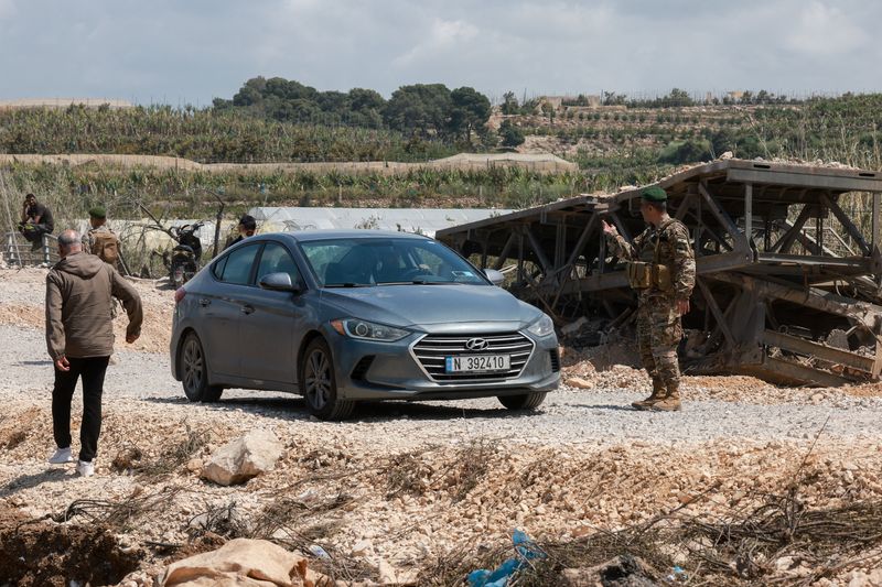 A member of the Lebanese army gestures at the site of an Israeli strike on a bridge carried out before a 10-day ceasefire between Israel and Lebanon went into effect, in Qasmiyeh, Southern Lebanon, April 20, 2026. REUTERS/Aziz Taher
