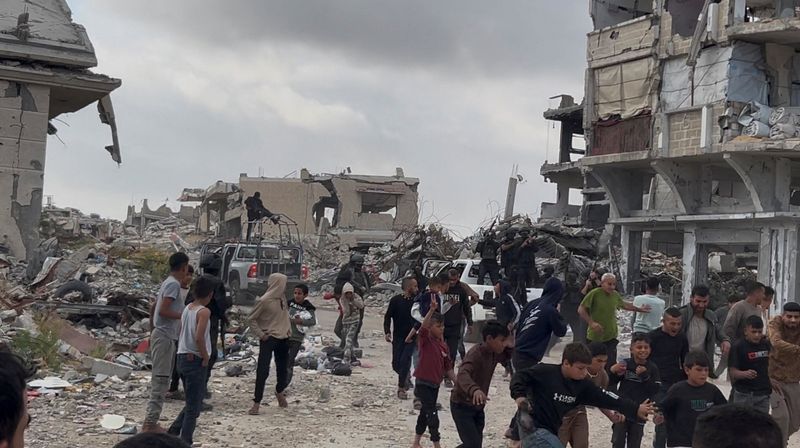 People react near Palestinians fighters after clashes with Israeli-backed militia, in Khan Younis, in the southern Gaza Strip, April 20, 2026, in this screengrab obtained from a video. Video obtained by REUTERS
