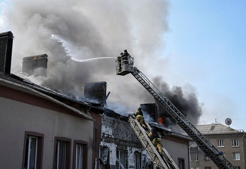 Firefighters work at the site of a building hit by a Russian drone strike, amid Russia's attack on Ukraine, in Zaporizhzhia, Ukraine, April 13, 2026. REUTERS/Stringer