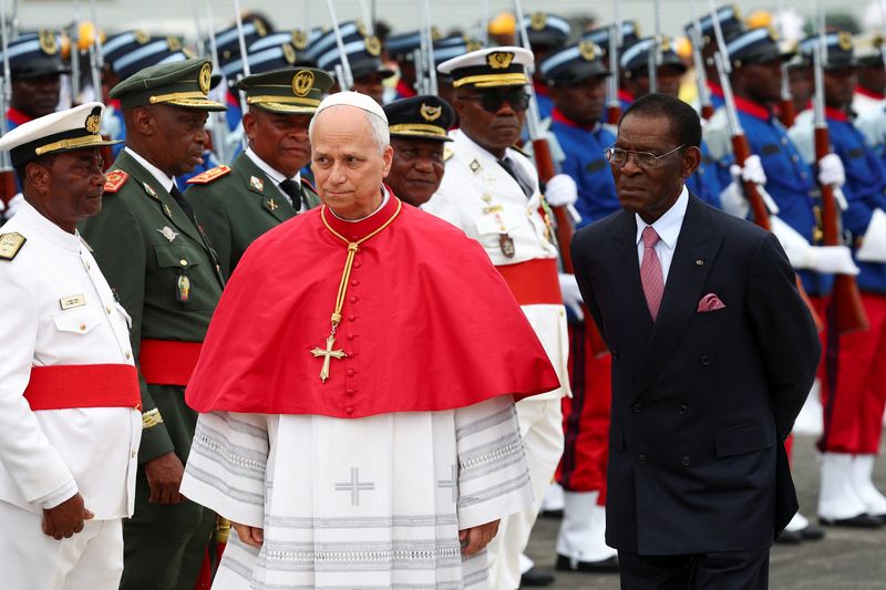 Pope Leo XIV walks next to President of Equatorial Guinea Teodoro Obiang Nguema Mbasogo upon his arrival at Malabo International Airport to begin his apostolic journey to Equatorial Guinea, in Malabo, Equatorial Guinea, April 21, 2026. REUTERS/Guglielmo Mangiapane