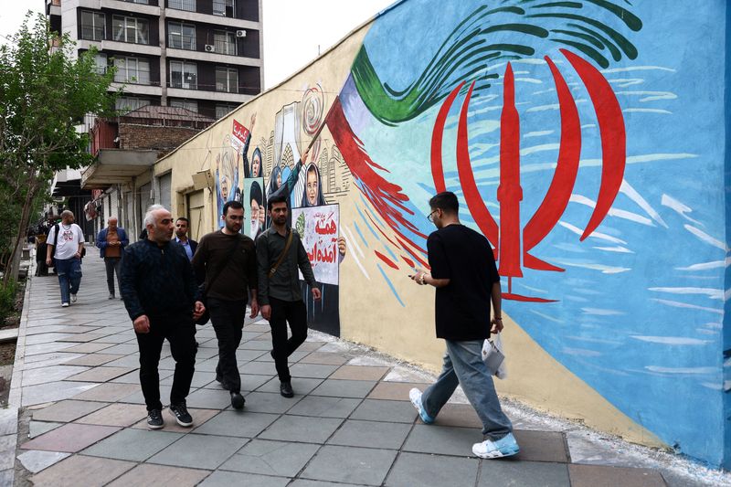 People walk on a street, amid a ceasefire between U.S. and Iran, in Tehran, Iran, April 20, 2026. Majid Asgaripour/WANA (West Asia News Agency) via REUTERS