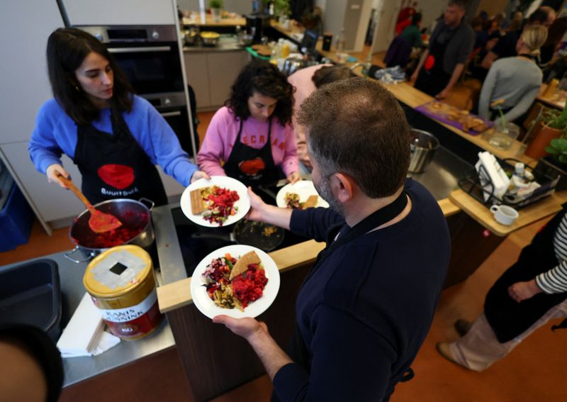 Salman (40), a Syrian refugee, helps an NGO distribute food to homeless people in Amsterdam, Netherlands, March 28, 2026. REUTERS/Piroschka van de Wouw