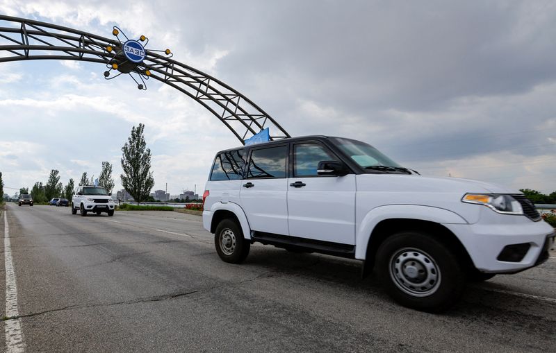 FILE PHOTO: A motorcade transporting members of the International Atomic Energy Agency (IAEA) expert mission, escorted by the Russian military, drives along a road while leaving the Zaporizhzhia Nuclear Power Plant in the course of Russia-Ukraine conflict outside Enerhodar in the Zaporizhzhia region, Russian-controlled Ukraine, June 15, 2023. REUTERS/Alexander Ermochenko/File Photo