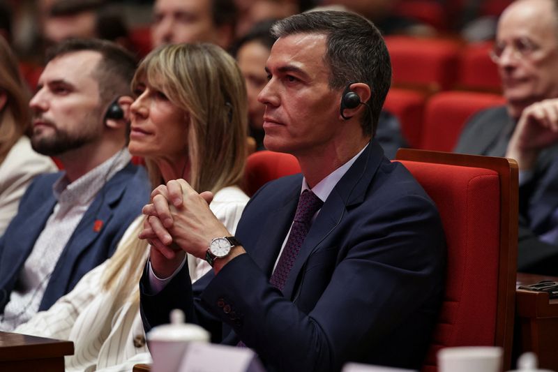 Spanish Prime Minister Pedro Sanchez (C), and his wife Begona Gomez, attend a speech at Tsinghua University, in Beijing, China, 13 April, 2026. ANDRES MARTINEZ CASARES/Pool via REUTERS/File Photo