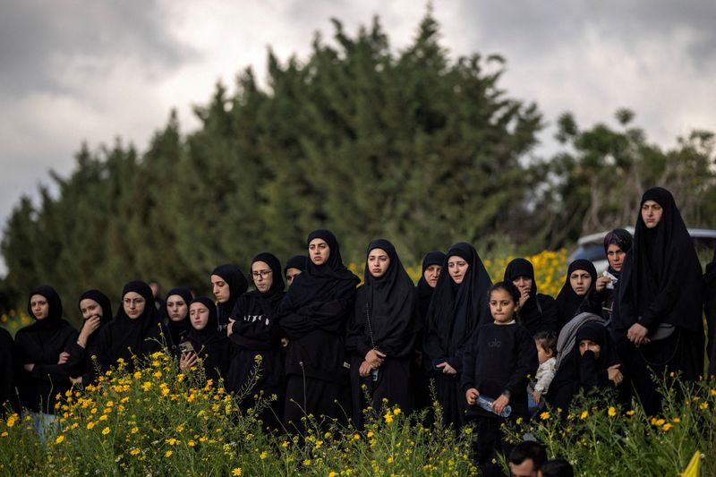 Mourners attend the funeral of people, including Hezbollah members, who were killed during the conflict with Israel before a 10-day ceasefire between Lebanon and Israel went into effect, in Kfar Sir, Lebanon. REUTERS/Marko Djurica