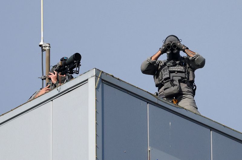 Members of Police take position on top of a building in The Hague, Netherlands June 25, 2025. REUTERS/Toby Melville