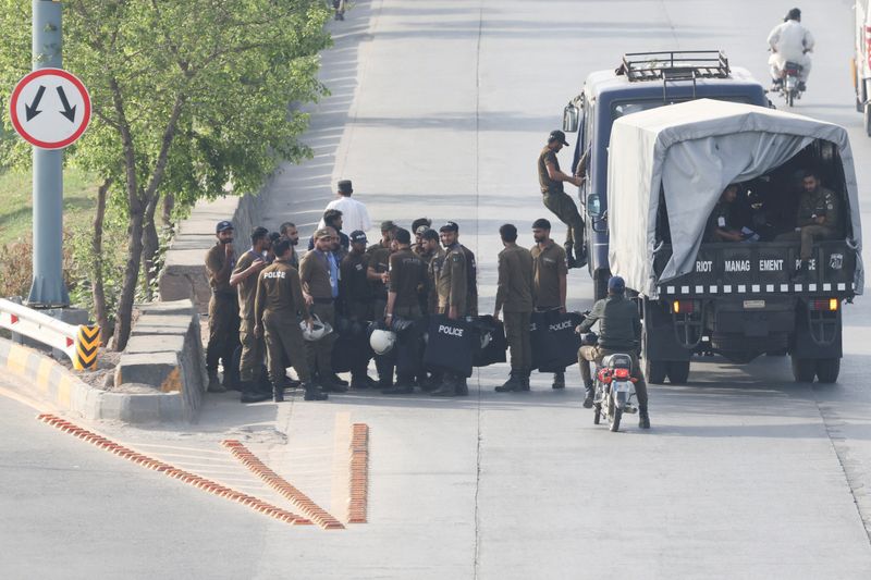 Police officers arrive on a road, following the suspension of transport and closure of markets on security restrictions, as Pakistan prepares to host U.S. and Iran for the second phase of peace talks in Islamabad, Pakistan, April 24, 2026. REUTERS/Akhtar Soomro