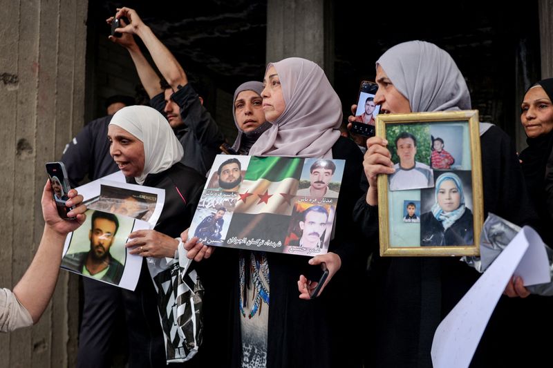 Residents gather in a street after Friday prayers to celebrate the arrest of Amjad Yousef, a key suspect in the 2013 Tadamon massacre, in Tadamon, Syria, April 24, 2026. REUTERS/Khalil Ashawi
