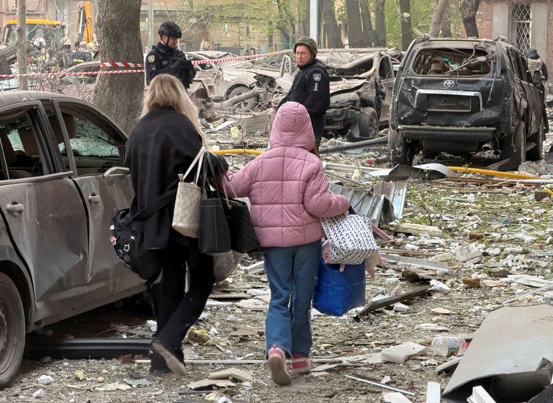 Residents leave the site of an apartment building hit by a Russian drone and missile strike, amid Russia's attack on Ukraine, in Dnipro, Ukraine April 25, 2026. Picture taken using a mobile phone. REUTERS/Serhii Chalyi