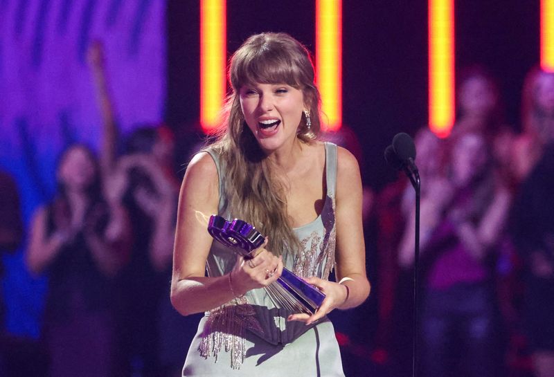 FILE PHOTO: Taylor Swift reacts with the Artist of the Year award at the 2026 iHeartRadio Music Awards at the Dolby Theatre in Los Angeles, California, U.S., March 26, 2026. REUTERS/Mario Anzuoni/File Photo