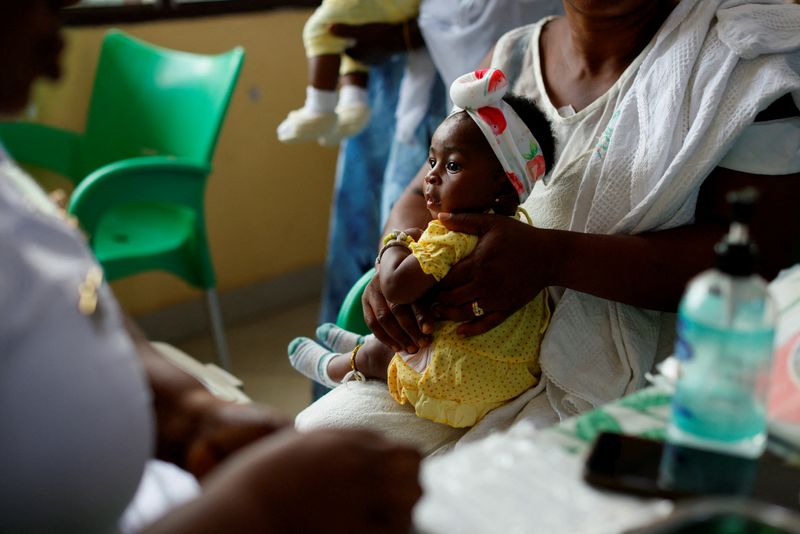 FILE PHOTO: An infant waits to receive a dose of the RTS,S malaria vaccine, also known as Mosquirix, at the Mother and Child Hospital in Kasoa, Ghana, November 19, 2025. REUTERS/Francis Kokoroko/File Photo