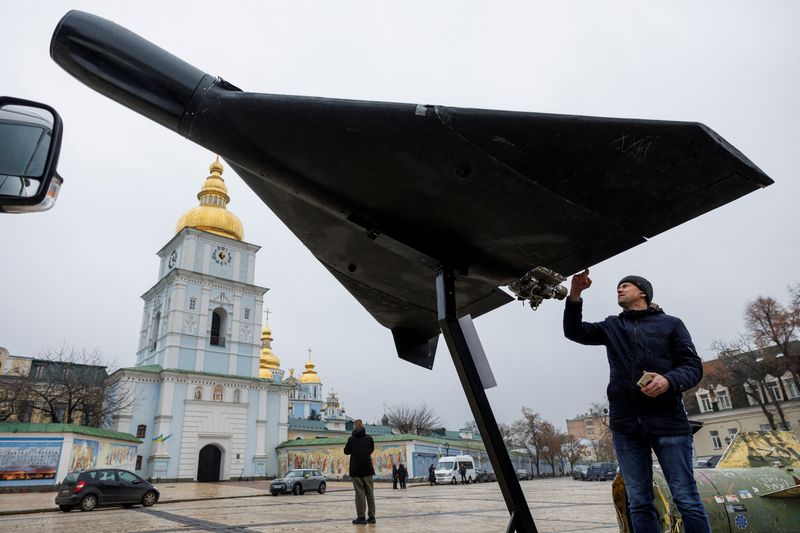 A resident touches a Russian-Iranian Shahed-136 (Geran-2) kamikaze drone installed in front of Saint Michael's Cathedral as a part of an exhibition displaying destroyed Russian military vehicles and weapons, amid Russia's attack on Ukraine, in Kyiv, Ukraine November 26, 2025. REUTERS/Valentyn Ogirenko