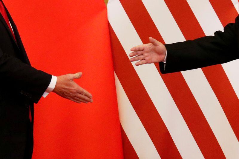 U.S. President Donald Trump and China's President Xi Jinping shake hands after making joint statements at the Great Hall of the People in Beijing, China, November 9, 2017. REUTERS/Damir Sagolj/File Photo