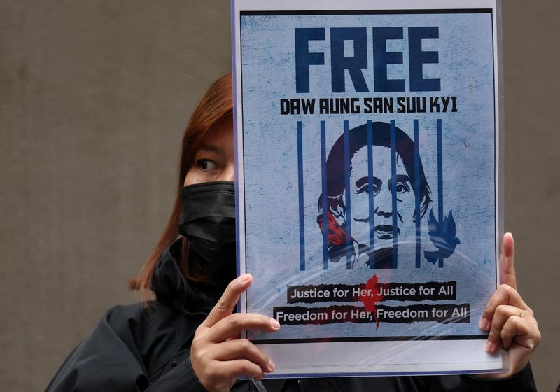 FILE PHOTO: A Myanmar protester living in Japan holds a placard of Myanmar's detained former leader, Aung San Suu Kyi, during a rally denouncing an upcoming election led by the military junta, outside Myanmar's embassy in Tokyo, Japan, December 14, 2025. REUTERS/Issei Kato/File Photo