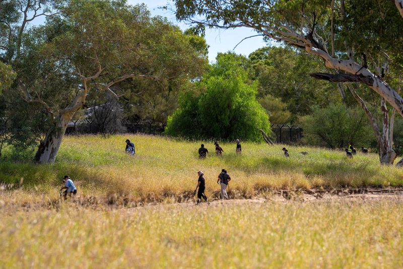 Volunteers join the police and emergency services in searching the scrubland surrounding Todd River on the third day of the search for a missing 5-year-old, whose family has asked her to be referred to as "Kumanjayi Little Baby" for cultural reasons, in Alice Springs, Australia, April 28, 2026. AAP/Rhett Hammerton via REUTERS