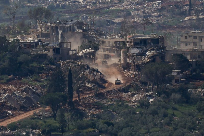 An Israeli military vehicle drives past destroyed buildings in Lebanon, as seen from the Israeli side of the Israel-Lebanon border, April 30, 2026. REUTERS/Shir Torem
