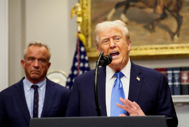 FILE PHOTO: U.S. President Donald Trump, next to U.S. Secretary of Health and Human Services Robert F. Kennedy Jr., makes an announcement linking autism to childhood vaccines and to the use of popular pain medication Tylenol for pregnant women and children, claims which are not backed by decades of science, at the White House, in Washington, D.C., U.S., September 22, 2025. REUTERS/Kevin Lamarque/File Photo