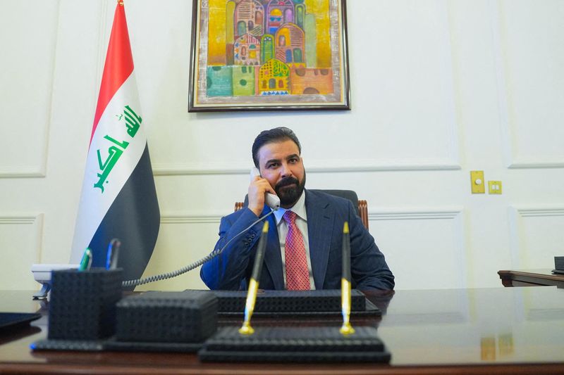 FILE PHOTO: New Iraqi Prime Minister designate Ali al-Zaidi, uses a phone at his office in Baghdad, Iraq, April 28, 2026. Iraqi Prime Minister’s Media Office/Handout via REUTERS/File Photo