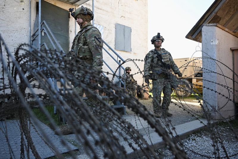 Soldiers stand next to a razor wire at a media day during the U.S. Army Combined Resolve exercise at the U.S. Army's southern Germany training facilities in Hohenfels, Germany, April 30, 2026. REUTERS/Angelika Warmuth
