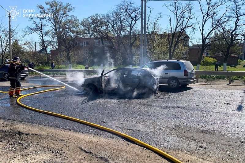 A firefighter extinguishes a car, which was damaged during a Russian missile strike in the town of Merefa, amid Russia's attack on Ukraine, in the Kharkiv region, Ukraine, May 4, 2026. Press service of the State Emergency Service of Ukraine in Kharkiv region/Handout via REUTERS