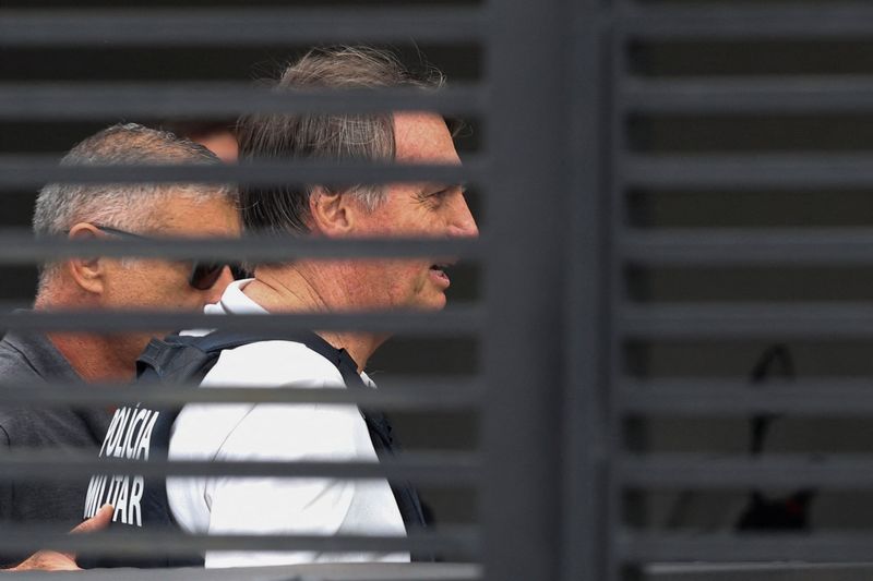 Former Brazilian President Jair Bolsonaro arrives home to begin serving house arrest following authorization by Supreme Court Justice Alexandre de Moraes, after Bolsonaro was convicted by a Supreme Court majority of plotting a coup to remain in power after losing the 2022 election, in Brasilia, Brazil March 27, 2026. REUTERS/Adriano Machado/File Photo