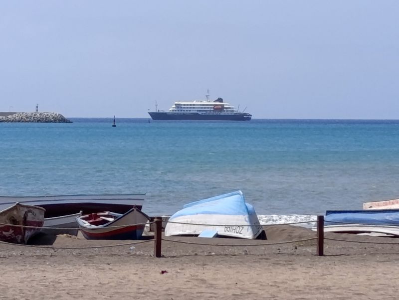 Cruise ship MV Hondius docks off Cape Verde port, as passengers were not allowed off the ship, while health authorities investigated suspected cases of hantavirus aboard the vessel, in Praia Port, Cape Verde, May 4, 2026.  REUTERS/Stringer