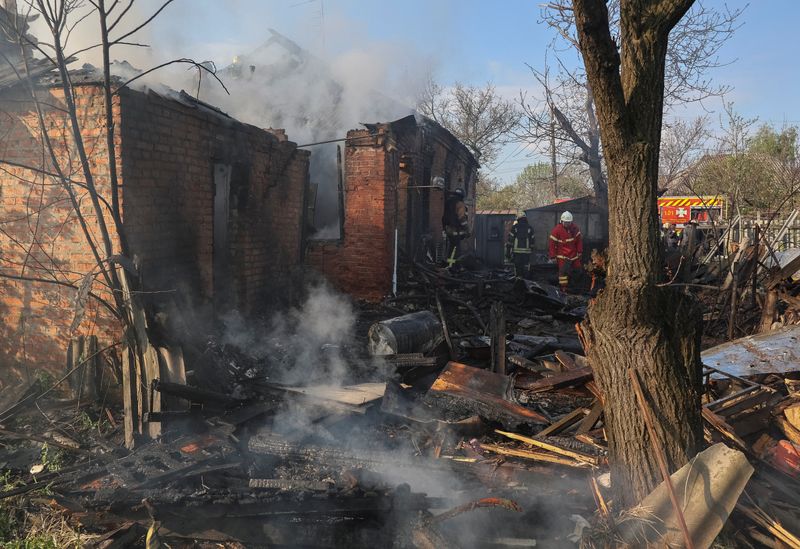 Rescuers work at the site of the private house hit by a Russian drone strike, amid Russia's attack on Ukraine, in Kharkiv, Ukraine May 6, 2026.  REUTERS/Vyacheslav Madiyevskyy