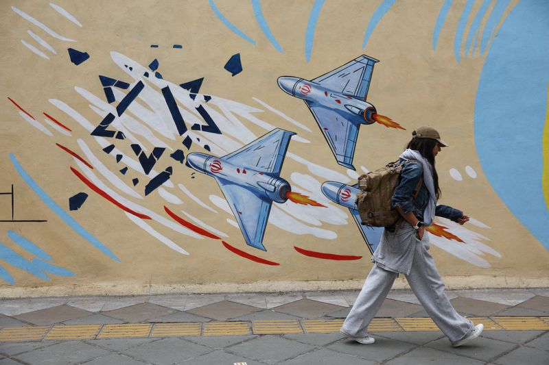 An Iranian woman walks next to an anti-Israeli mural on a street in Tehran, Iran, May 5, 2026. Majid Asgaripour/WANA (West Asia News Agency) via REUTERS