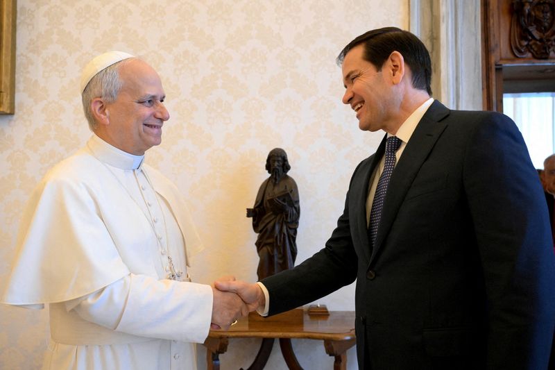 FILE PHOTO: Pope Leo XIV shakes hands with U.S. Secretary of State Marco Rubio as they meet at the Vatican, May 19, 2025. Vatican Media/­Simone Risoluti/Handout via REUTERS /File Photo