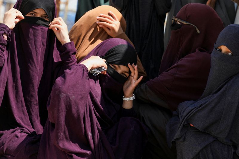 Members of Australian families believed to be linked to the Islamic State militants wait to leave Roj camp near Derik, Syria April 24, 2026. REUTERS/Orhan Qereman