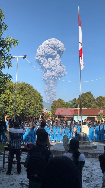 People watch as smoke rises after the eruption of Mount Dukono in North Halmahera Regency, North Maluku, Indonesia, May 8, 2026, in this screengrab obtained from a social media video. Jhon Frengki Manipa/via REUTERS