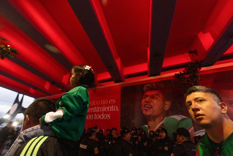Fans walk near Azteca Stadium, officially renamed Estadio Banorte, on the day of a friendly match between the national teams of Mexico and Portugal held to mark the stadium's inauguration, as Mexico prepares for the 2026 FIFA World Cup co-hosted by the United States, Canada and Mexico, in Mexico City, Mexico, March 28, 2026. REUTERS/Quetzalli Nicte-Ha