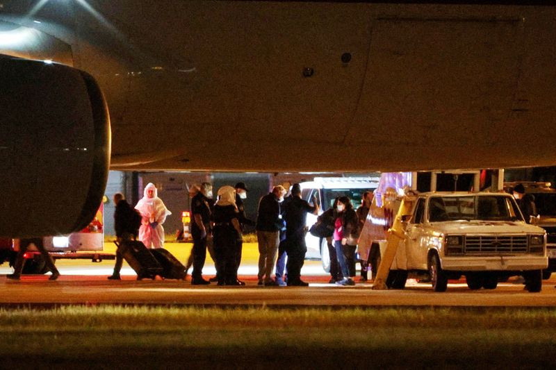 Personnel from various agencies assist in the disembarkation of passengers evacuated from the cruise ship MV Hondius, which was affected by a hantavirus outbreak, and arrived on a chartered aircraft at Eppley Airfield in Omaha, Nebraska, U.S. May 11, 2026.  REUTERS/Hayden Smith