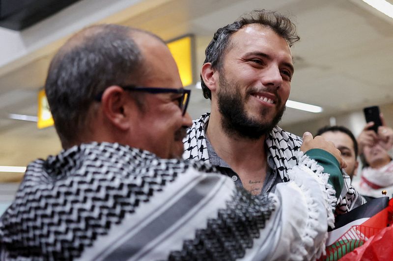 Brazilian activist Thiago Avila, who was detained aboard the Gaza-bound Global Sumud Flotilla, which was intercepted by Israeli forces, is embraced as he arrives at Sao Paulo/Guarulhos International Airport after being deported, in Guarulhos, Brazil, May 11, 2026. REUTERS/Amanda Perobelli
