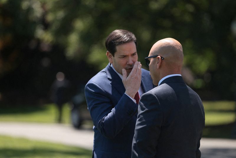 U.S. Secretary of State Marco Rubio talks with White House Director of Oval Office Operations Walt Nauta, ahead of U.S. President Donald Trump's departure from the White House for Joint Base Andrews en route to Beijing, China, in Washington, D.C., U.S., May 12, 2026. REUTERS/Evelyn Hockstein