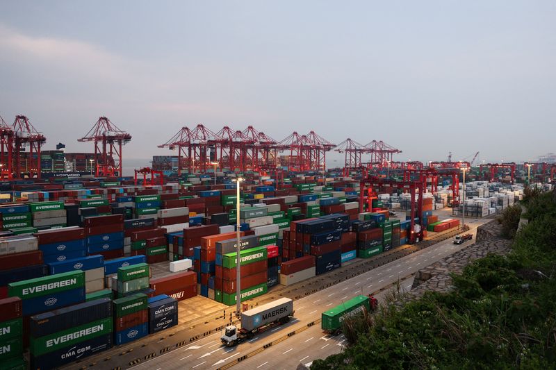 Gantry cranes stand near stacked shipping containers at Yangshan Port outside Shanghai, China, May 7, 2026.  REUTERS/Go Nakamura