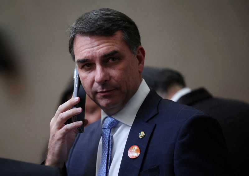 FILE PHOTO: Senator Flavio Bolsonaro uses his phone in Brasilia, Brazil, May 12, 2026.REUTERS/Adriano Machado/File Photo