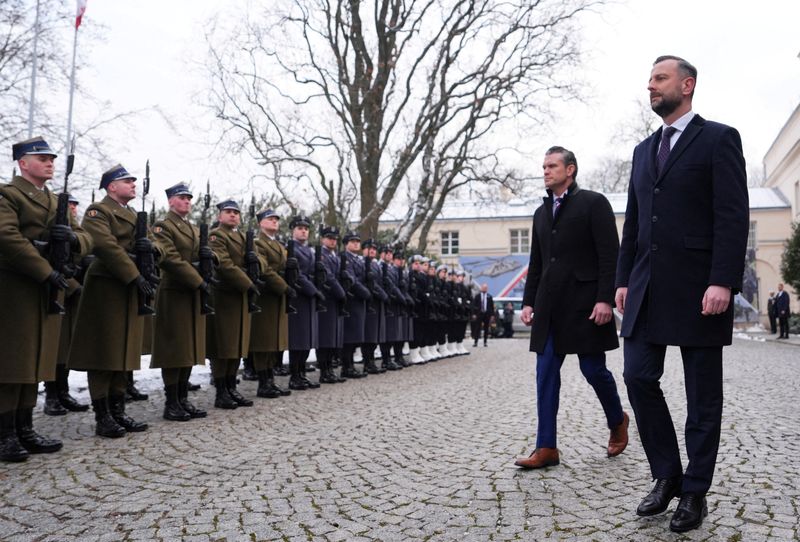 FILE PHOTO: U.S. Defense Secretary Pete Hegseth and Poland's Deputy Prime Minister and Defence Minister Wladyslaw Kosiniak-Kamysz review an honorary guard as they meet in Warsaw, Poland, February 14, 2025. REUTERS/Aleksandra Szmigiel/File Photo