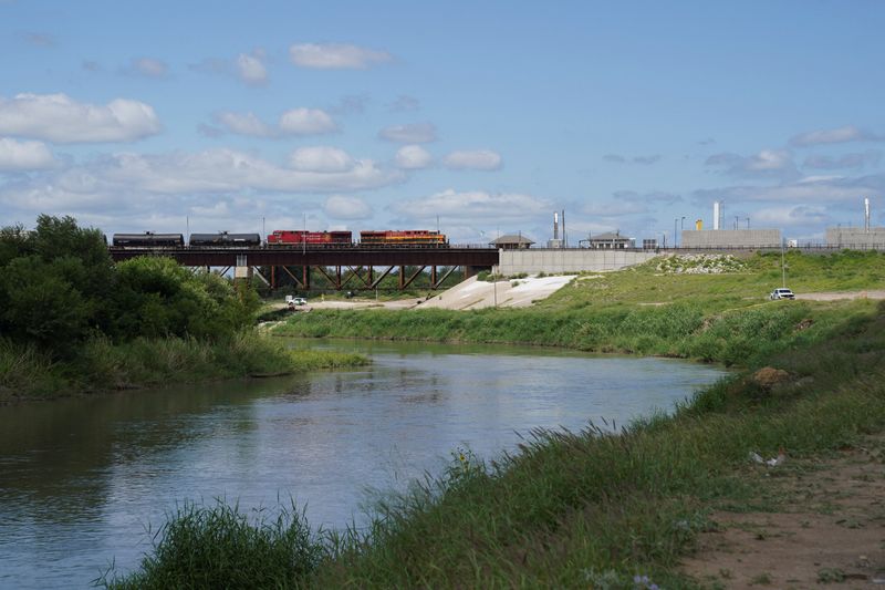 A freight train coming from Mexico crosses the border after six bodies were found on Sunday in a train boxcar, in Laredo, Texas, U.S. May 11, 2026.  REUTERS/Gabriel V. Cardenas