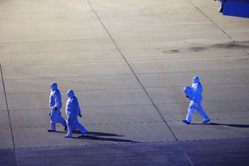 FILE PHOTO: Personnel in hazmat suits walk near a plane carrying passengers evacuated from the cruise ship MV Hondius, which was affected by a hantavirus outbreak, after it landed at the Eindhoven Air Base in Eindhoven, Netherlands May 12, 2026. REUTERS/Piroschka van de Wouw/File Photo