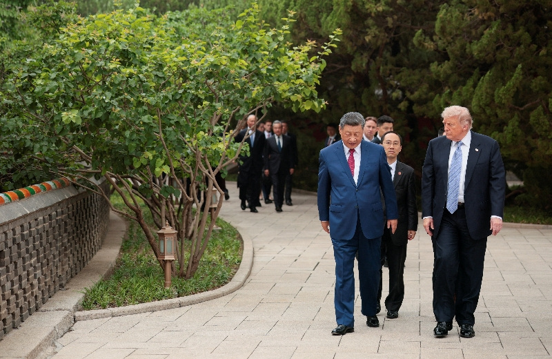 U.S. President Donald Trump walks with Chinese President Xi Jinping while leaving after a visit to the Zhongnanhai Garden in Beijing, China, May 15, 2026. REUTERS/Evan Vucci/Pool