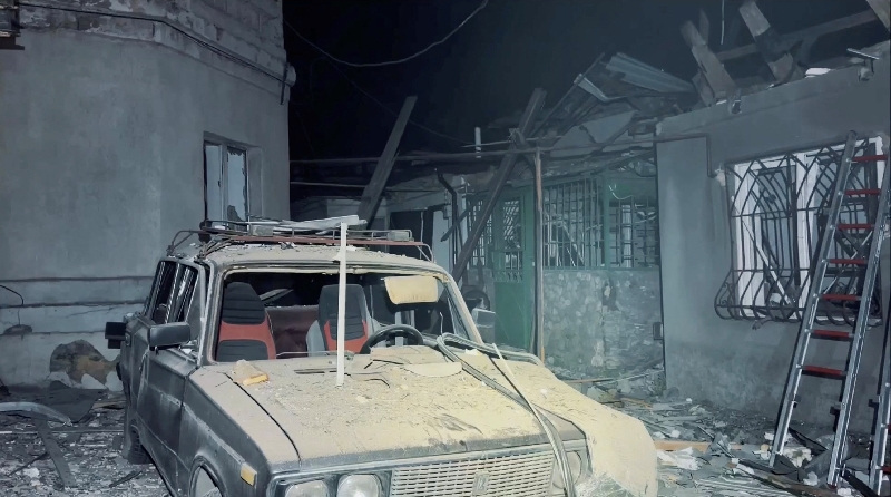 A destroyed car and damaged buildings at the site of a Russian drone strike, amid Russia's attack on Ukraine, in a location given as Odesa, Ukraine, in this screengrab obtained from a handout video released on May 18, 2026. Odesa City Council via Telegram/Handout via REUTERS