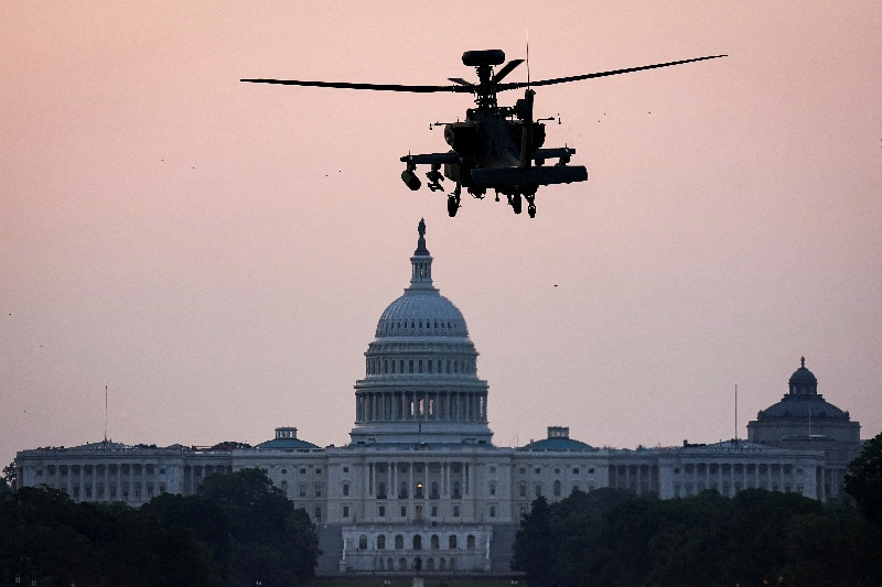 A Boeing AH-64 Apache attack helicopter to be used in the U.S. Army's 250th Birthday Celebration and Parade, prepares to land on the National Mall near the U.S. Capitol in Washington, D.C., U.S., June 11, 2025. REUTERS/Al Drago