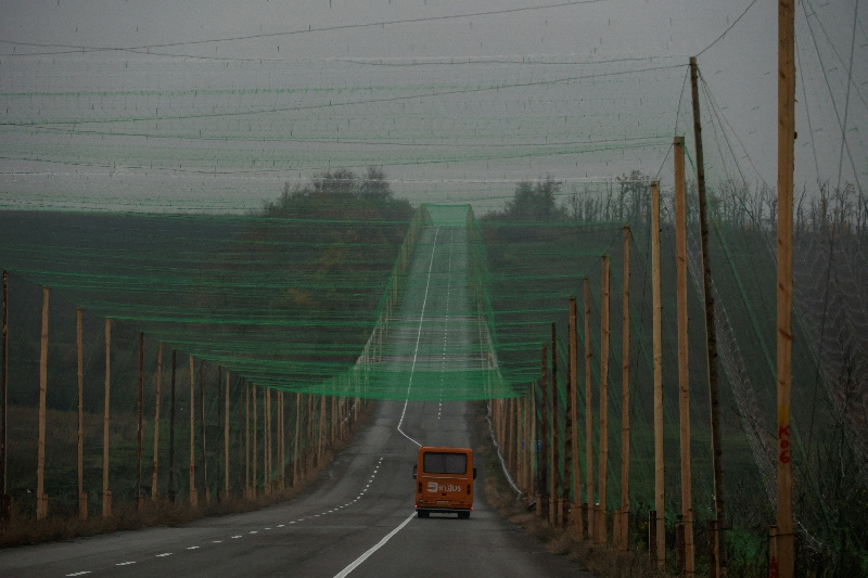 FILE PHOTO: A car drives along a road covered with an anti-drone net, amid Russia's attack on Ukraine, near the town of Sloviansk in Donetsk region, Ukraine October 27, 2025. REUTERS/Sofiia Gatilova/File Photo