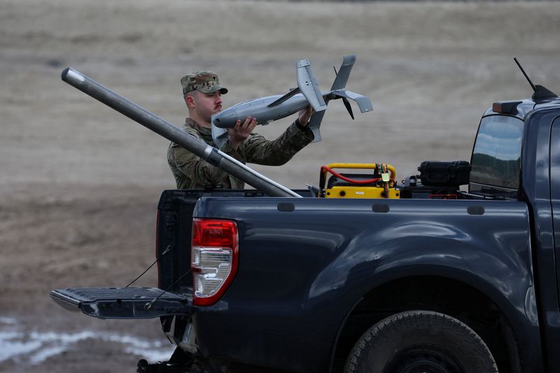 A U.S. soldier installs an AS3 interceptor, part of a modular American-made AI-powered counter-drone system, MEROPS on the back of a truck during a presentation at a polygon in Nowa Deba, Poland, November 18, 2025. REUTERS/Kacper Pempel