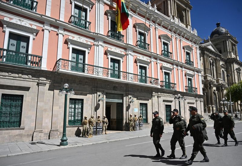 Police officers walk near the Government Palace as military personnel guard the area amid social unrest in La Paz, Bolivia May 19, 2026. REUTERS/Claudia Morales/File Photo